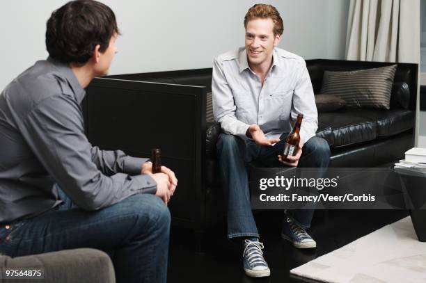 two men having beer - leaning on elbows stock pictures, royalty-free photos & images