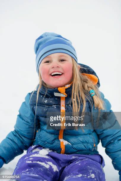 girl smiling with snow in the face - erik buraas stock-fotos und bilder