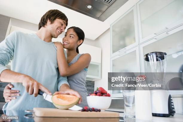 couple preparing smoothies - young urban professional person stock-fotos und bilder