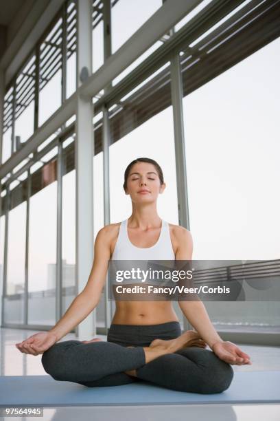 woman doing yoga - young urban professional person stock-fotos und bilder