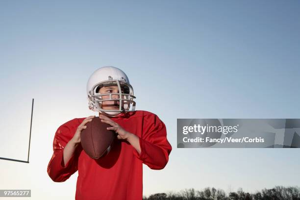 boy preparing to throw football - kid throwing stock pictures, royalty-free photos & images