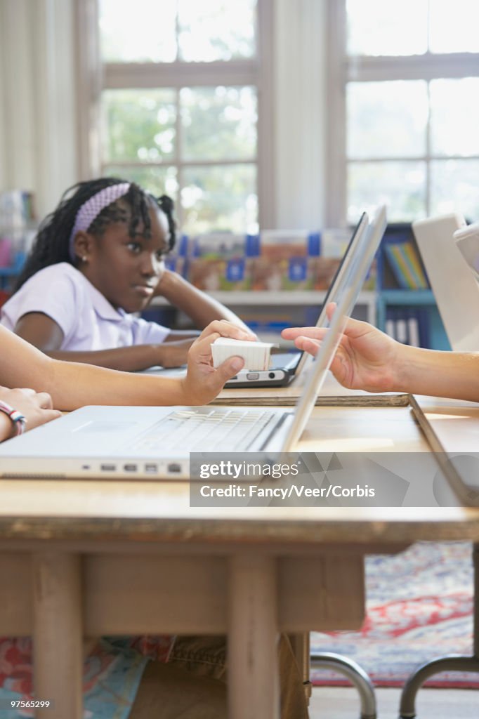 Students passing note in class