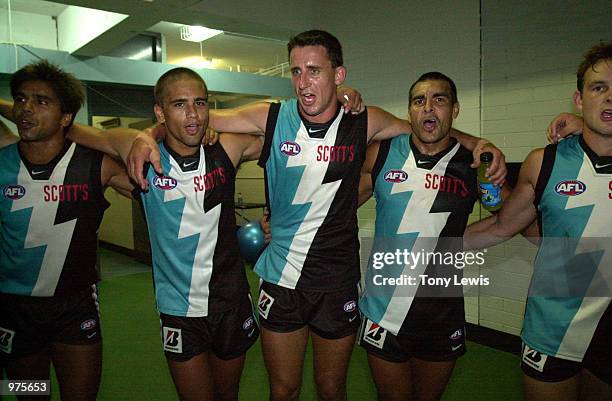 Port Adelaide players sing the club song after their win in the match between Port Power and the Sydney Swans played at Football Park in Adelaide,...