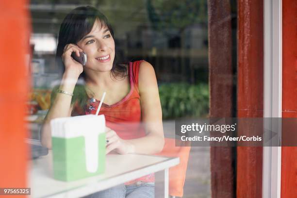 young woman using cell phone in cafe - napkin holder stock pictures, royalty-free photos & images