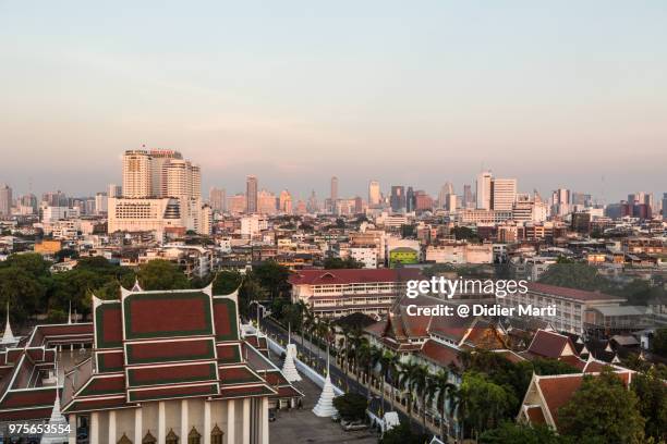 sunset over bangkok skyline and a buddhist temple in the heart of bangkok old town in thailand capital city - didier marti stock pictures, royalty-free photos & images