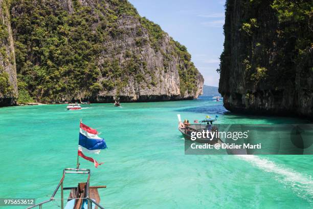 long tail boat around the stunning ko phi phi island in krabi province in south thailand - didier marti stock pictures, royalty-free photos & images