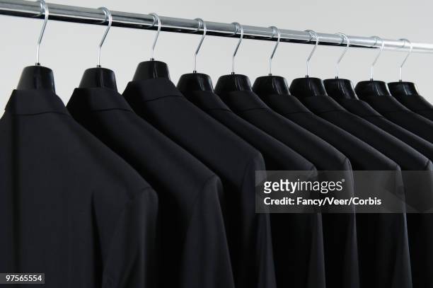 row of hanging suits - 徹底 ストックフォトと画像