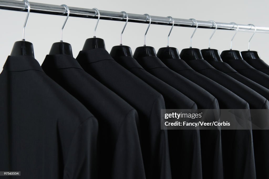 Row of hanging suits