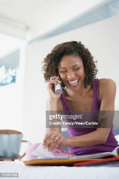 woman using cordless phone - undershirt stock pictures, royalty-free photos & images
