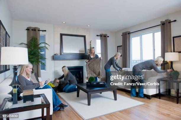 woman busy cleaning living room - day in the life series - fotografias e filmes do acervo