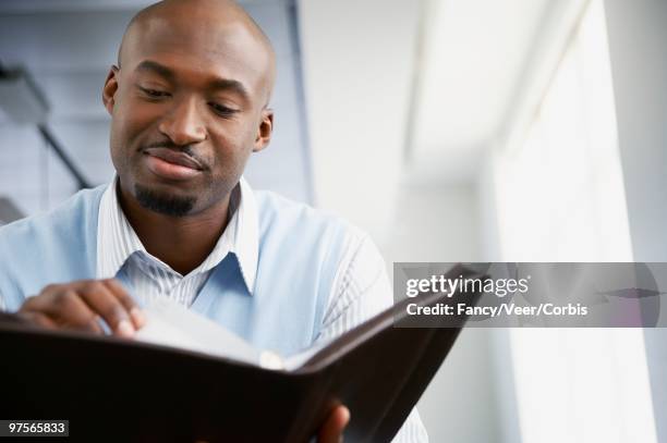 businessman looking at appointment book - imagem super exposta - fotografias e filmes do acervo