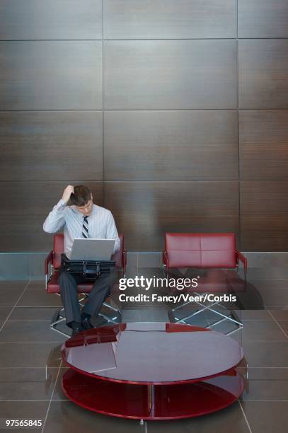 businessman using a laptop - veer stock pictures, royalty-free photos & images