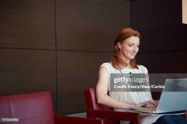 businesswoman using a laptop - veer stock pictures, royalty-free photos & images