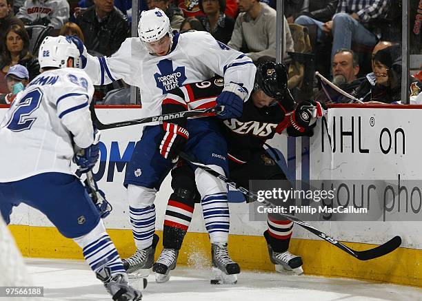 Nikolai Kulemin of the Toronto Maple Leafs battles for the puck with Milan Michalek of the Ottawa Senators in a game at Scotiabank Place on March 6,...