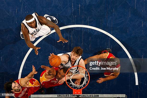 Marc Gasol of the Memphis Grizzlies goes after a rebound against Luis Scola, Chuck Hayes and Shane Battier of the Houston Rockets during the game on...