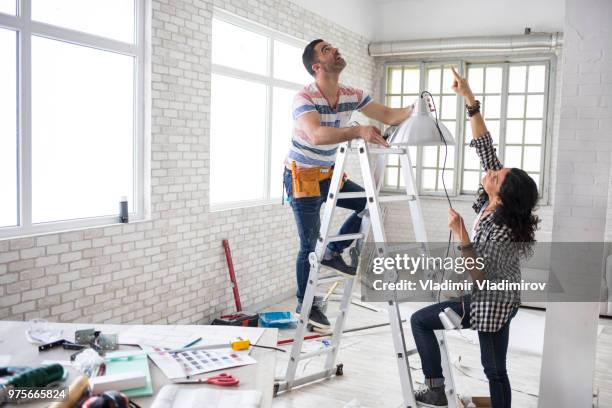 couple renovating their apartment - doing household chores stock pictures, royalty-free photos & images