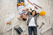 Couple renovating and resting on floor