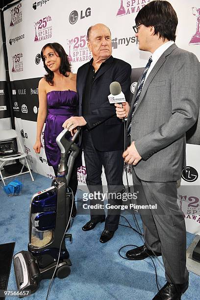 Presenters Shira Lazar and Mark Olsen interview actor Robert Duvall with the LG Electronics Kompressor Vacuum on The 25th Spirit Awards Blue Carpet...