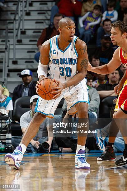 David West of the New Orleans Hornets handles the ball against David Andersen of the Houston Rockets during the game on February 21, 2010 at the New...
