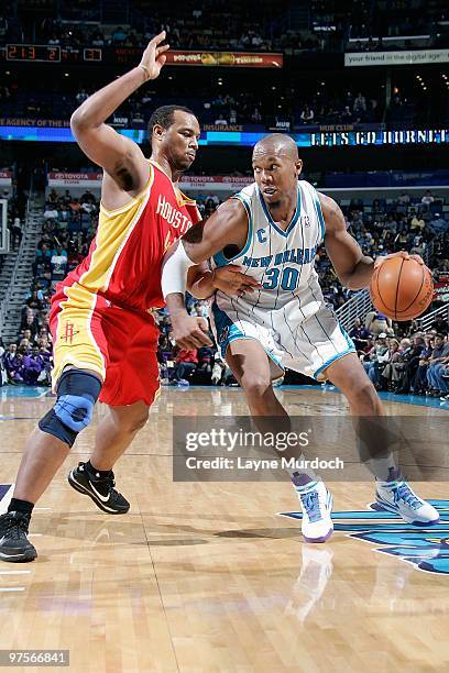 David West of the New Orleans Hornets handles the ball against Chuck Hayes of the Houston Rockets during the game on February 21, 2010 at the New...