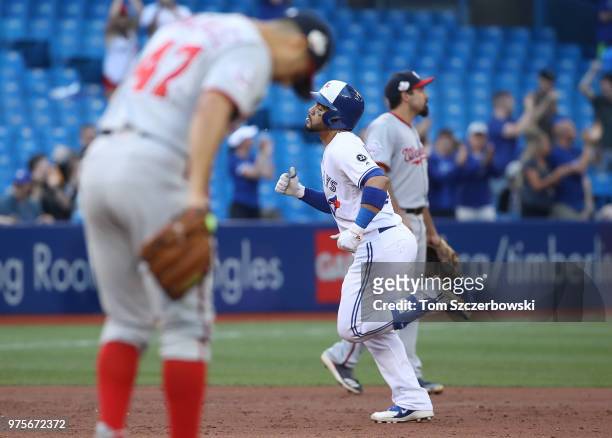 Devon Travis of the Toronto Blue Jays circles the bases after hitting a two-run home run in the third inning during MLB game action as Gio Gonzalez...