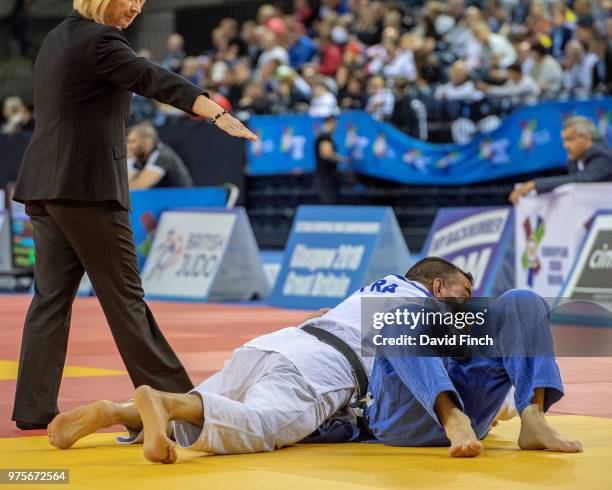 The referee signals a controlling hold by Mohamed Halabi of France against Thierry Lagoute, also of France, to win by an ippon as Halabi progressed...