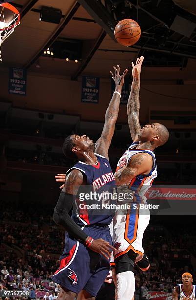 Marvin Williams of the Atlanta Hawks jumps for the rebound against Wilson Chandler of the New York Knicks on March 8, 2010 at Madison Square Garden...