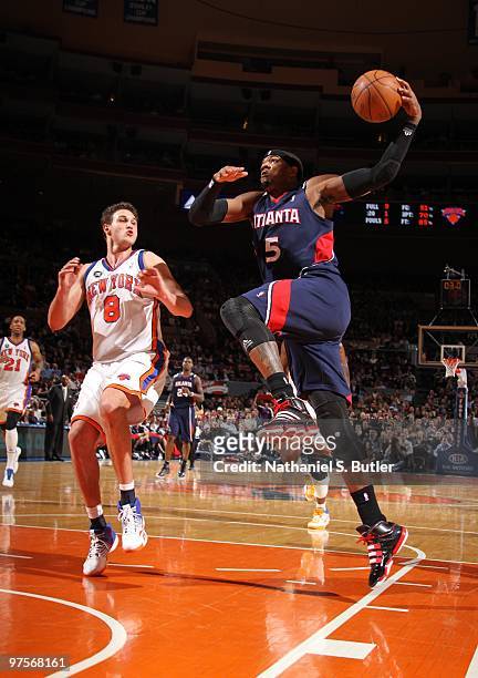 Josh Smith of the Atlanta Hawks shoots against Danilo Gallinari of the New York Knicks on March 8, 2010 at Madison Square Garden in New York City....