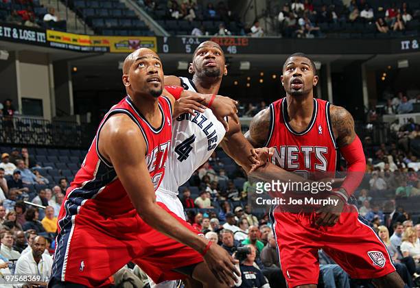 Sam Young of the Memphis Grizzlies is boxed out by Jarvis Hayes and Terrence Williams of the New Jersey Nets on March 8, 2010 at FedExForum in...