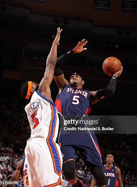 Josh Smith of the Atlanta Hawks shoots against Bill Walker of the New York Knicks on March 8, 2010 at Madison Square Garden in New York City. NOTE TO...