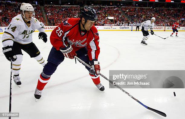 Jason Chimera of the Washington Capitals controls the puck against Jamie Benn of the Dallas Stars on March 8, 2010 at the Verizon Center in...