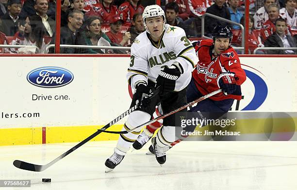 Stephane Robidas of the Dallas Stars controls the puck against Mike Knuble of the Washington Capitals on March 8, 2010 at the Verizon Center in...