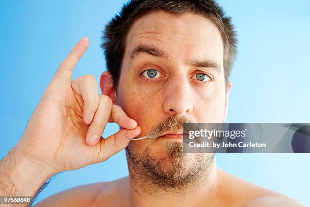 man with handlebar mustache twirls one end - handlebar mustache stock pictures, royalty-free photos & images