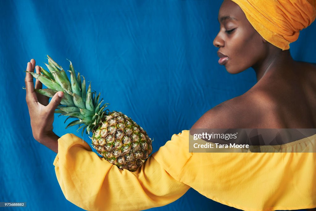 Woman holding pineapple