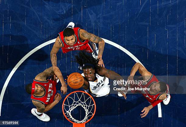 DeMarre Carroll of the Memphis Grizzlies battles for a rebound against Courtney Lee, Chris Douglas-Roberts, and Devin Harris of the New Jersey Nets...