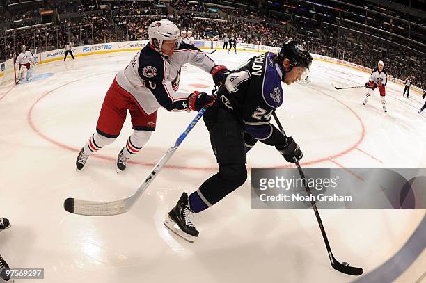 Alexander Frolov of the Los Angeles Kings skates with the puck against Anton Stralman of the Columbus Blue Jackets on March 8, 2010 at Staples Center...