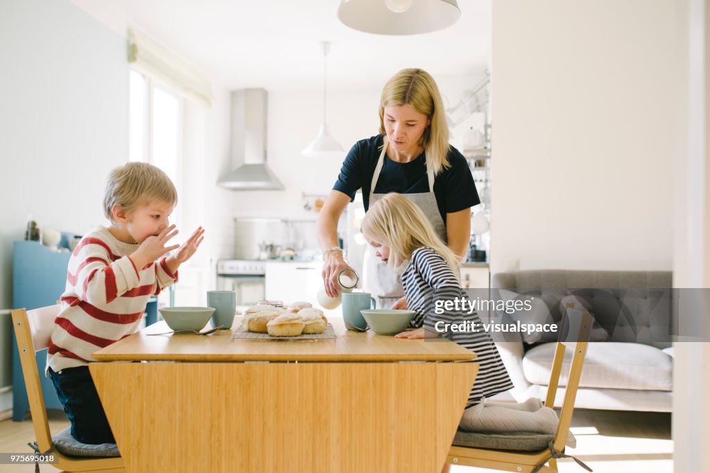 Nordic family eating semla buns on Shrove Tuesday