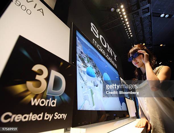 Model wearing 3D glasses stands next to Sony Corp.'s 3D Bravia televisions at their unveiling in Tokyo, Japan, on Tuesday, March 9, 2010. Sony Corp....