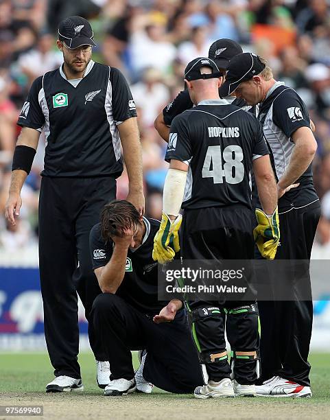 Shane Bond of New Zealand holds his hand in pain after getting hit by the ball during the One Day International match between New Zealand and...
