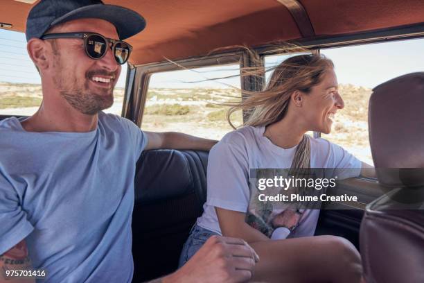 couple in back seat of car on road trip - friends inside car imagens e fotografias de stock