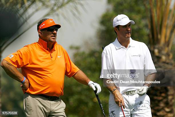 Sir Ian Botham and Michael Vaughan look on during the Laureus World Sports Awards Golf Challenge at the Abu Dhabi Golf Club on March 9, 2010 in Abu...