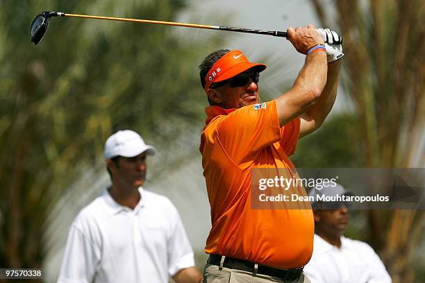 Sir Ian Botham tees off the 2nd hole as Michael Vaughan looks on during the Laureus World Sports Awards Golf Challenge at the Abu Dhabi Golf Club on...