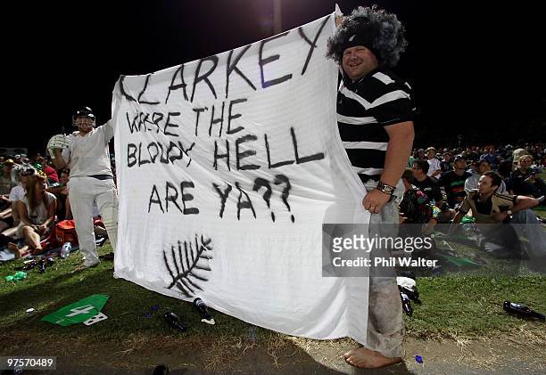 Cricket supporters hold up a banner referring to Michael Clarke's decision to quit the tour and return to Australia during the One Day International...