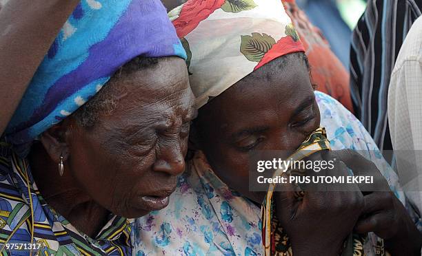 Woman wipes a tear after dead bodies mostly women and children were killed during religious clash between natives of Dogo Nahawa and Hausa Fulani...