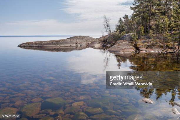 reflexion in lake of rocky coast. - reflexion stock pictures, royalty-free photos & images