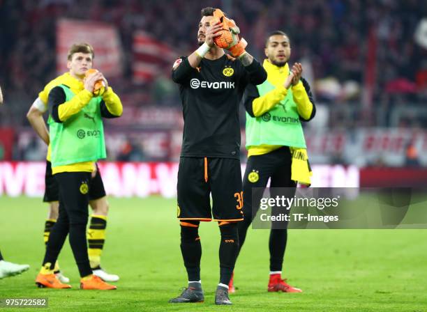 Sergio Gomez of Dortmund, Goalkeeper Roman Buerki of Dortmund and Jeremy Toljan of Dortmund look dejected after the Bundesliga match between FC...