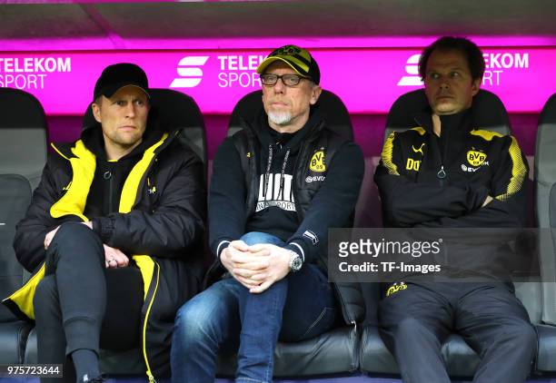 Assistant coach Alexander Bade of Dortmund, Head coach Peter Stoeger of Dortmund and Dr. Markus Braun look on prior to the Bundesliga match between...