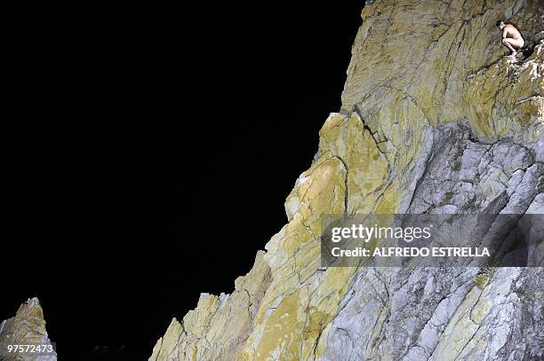 Cliff diver waits to jump from 'La Quebrada' cliff in Acapulco, Mexico, on March 1, 2010. The tradition of 'La Quebrada' goes back to 1934, when two...