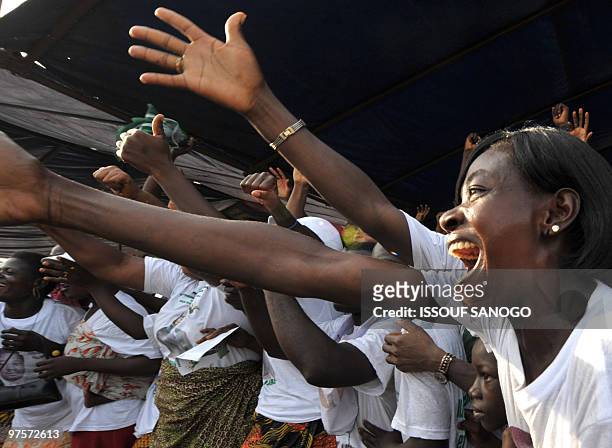 Supporters of Togo�s outgoing president Faure Gnassingbe, son of general Gnassingbe Eyadema and candidate of Rassemblement du Peuple Togolais dance...