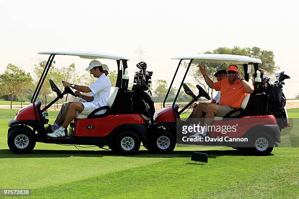Ian Botham gives Michael Vaughan a push in his buggie after it breaks down during the Laureus World Sports Awards Golf Challenge at the Abu Dhabi...